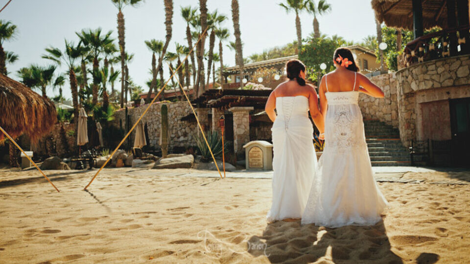 A lesbian couple celebrating their wedding on the beach in Los Cabos