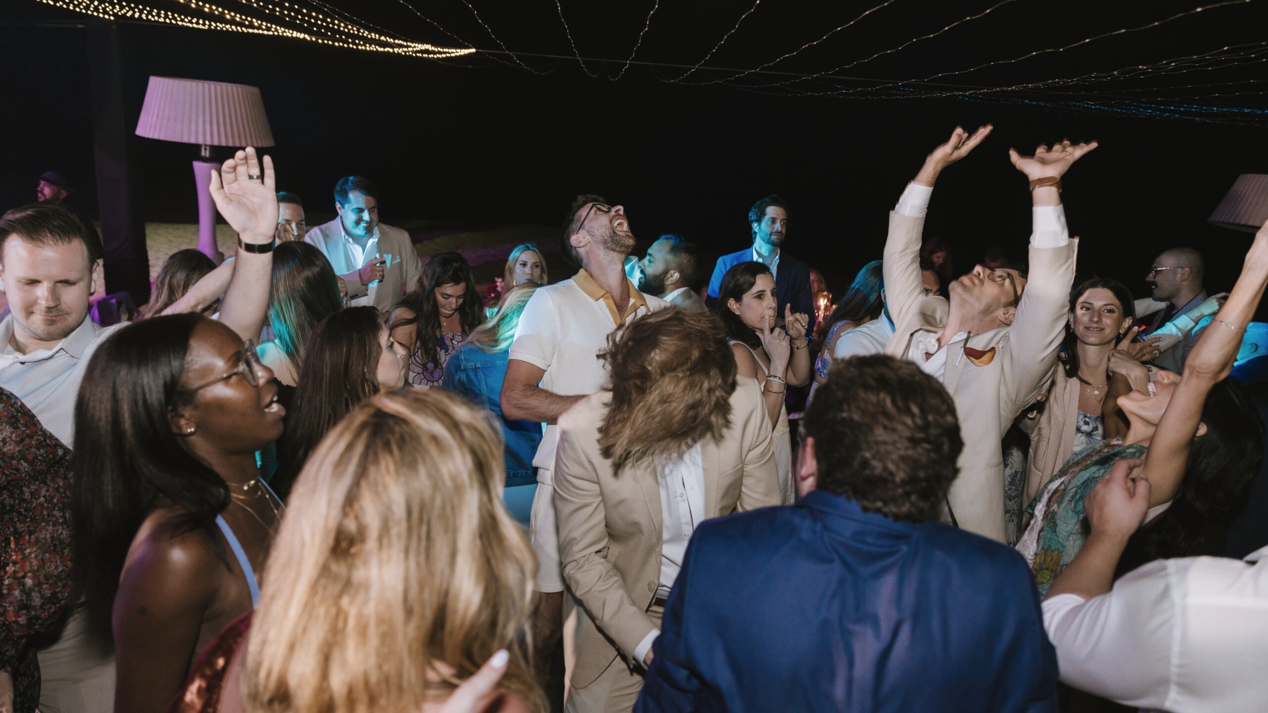 Guests have fun dancing at a destination wedding in Los Cabos