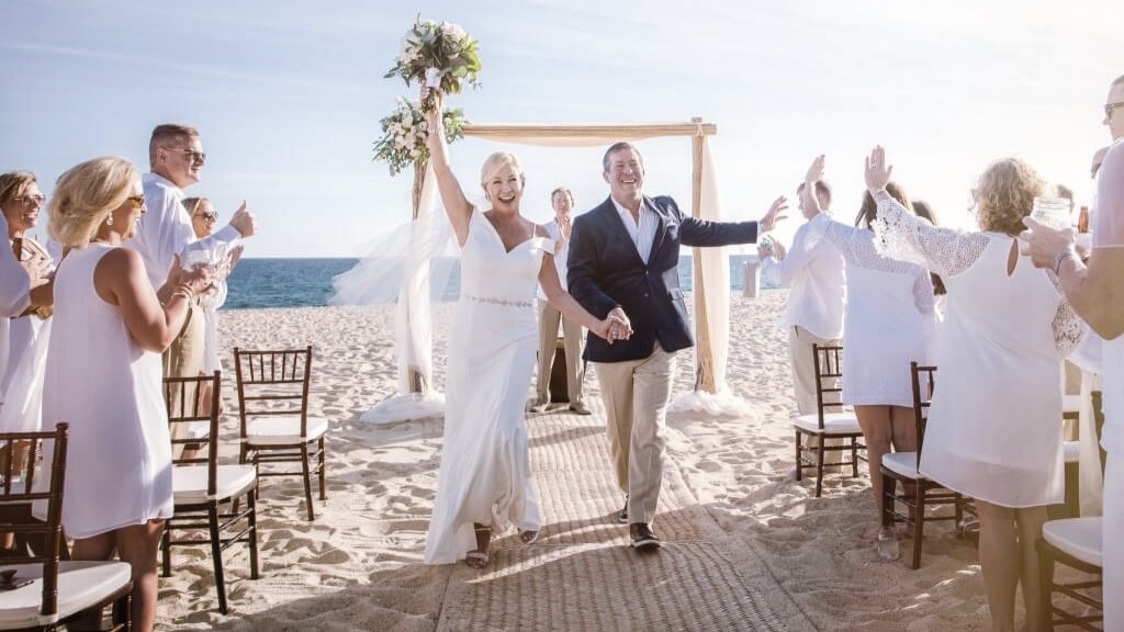 couple celebrates at the end of the ceremony during their wedding in Los Cabos